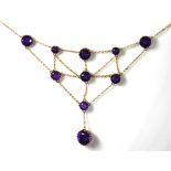 AN EDWARDIAN 15CT GOLD AND AMETHYST NECKLACE The arrangement of round cut graduated stones connected