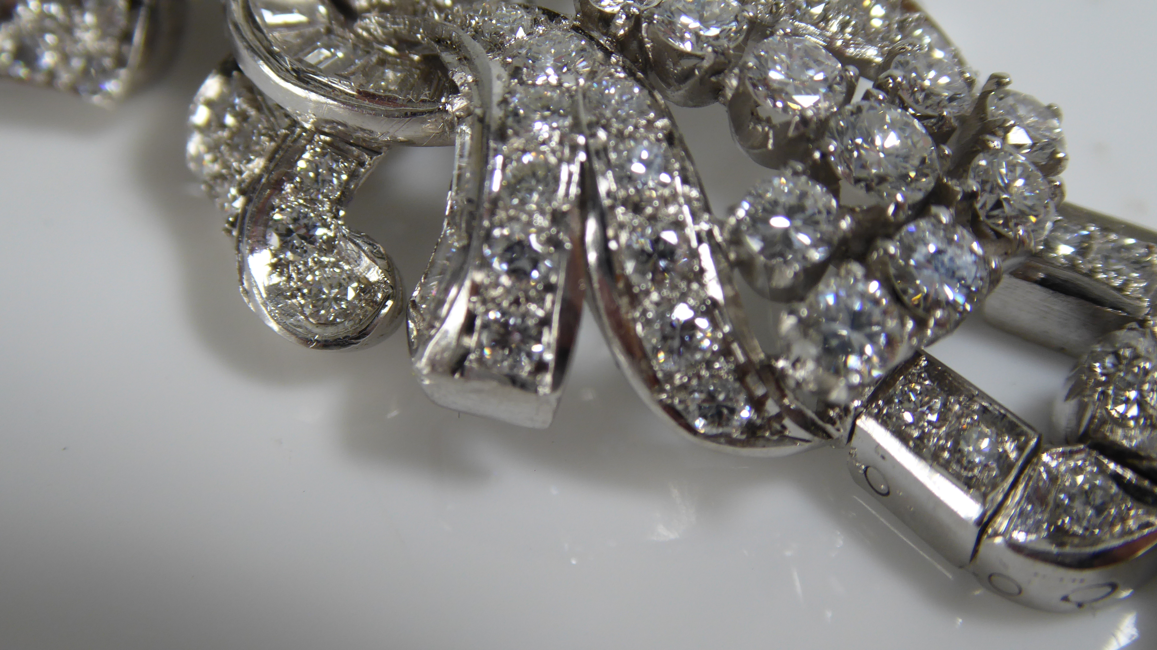 A PLATINUM AND DIAMOND BRACELET The arrangement of brilliant and baguette cut diamonds forming a - Image 4 of 8