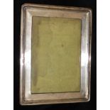 AN EDWARDIAN RECTANGULAR SILVER EASEL PHOTOGRAPH FRAME With beaded edge, hallmarked Birmingham,