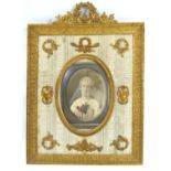 A LATE 19TH CENTURY GILT BRONZE RECTANGULAR PHOTOGRAPH FRAME With scrolled finial, embossed floral