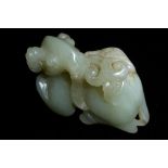 A CHINESE JADE CARVING OF A RAM Recumbent pose, with carved horns and beard. (approx 6.5cm x 4.5cm)