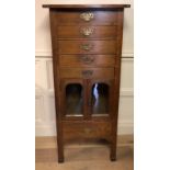 A 19TH CENTURY SOLID OAK PEDESTAL CHEST Having an arrangement of six drawers and a pair of glazed