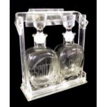 A 20TH CENTURY LUCITE AND GLASS TANTALUS Two glass decanters with Art Deco stoppers, engraved