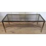 MANNER OF MAISON JANSEN, A 20TH CENTURY BRASS AND GLASS RECTANGULAR COFFEE TABLE Raised on reeded