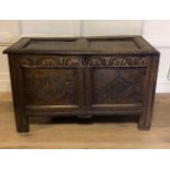 A 17TH CENTURY CARVED OAK PANELLED COFFER With hinged lid. (h 62cm x w 100cm x d 48cm)