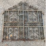 A PAIR OF DECORATIVE 20TH CENTURY SCROLLNG WROUGHT IRON GARDEN GATES. (133cm x 123cm)