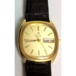 OMEGA, A VINTAGE GOLD PLATED GENT'S WRISTWATCH Having a rectangular gold tone dial with calendar