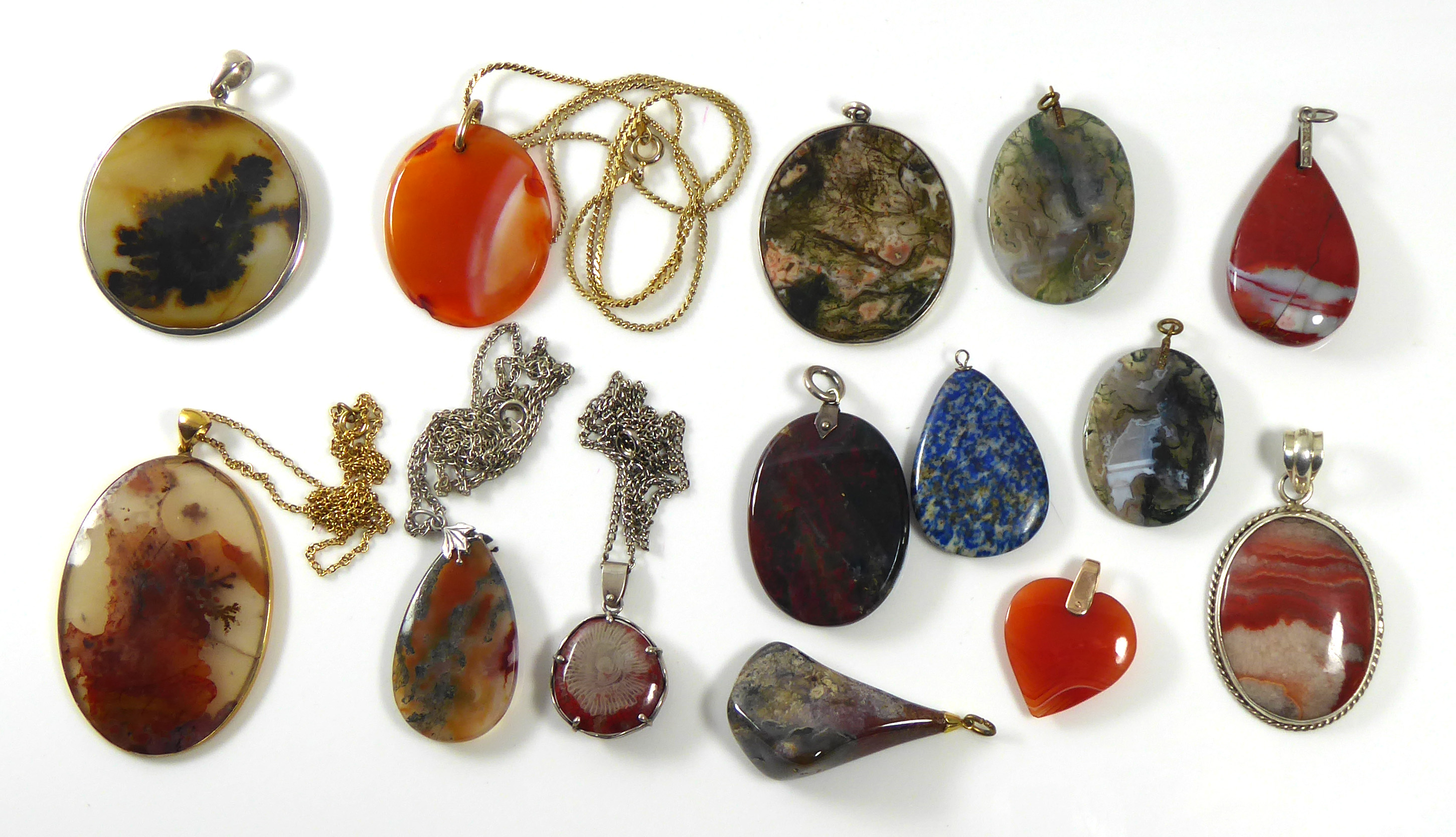 A COLLECTION OF TWELVE VINTAGE AGATE PENDANTS Various forms including an oval cut stone with