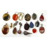A COLLECTION OF TWELVE VINTAGE AGATE PENDANTS Various forms including an oval cut stone with