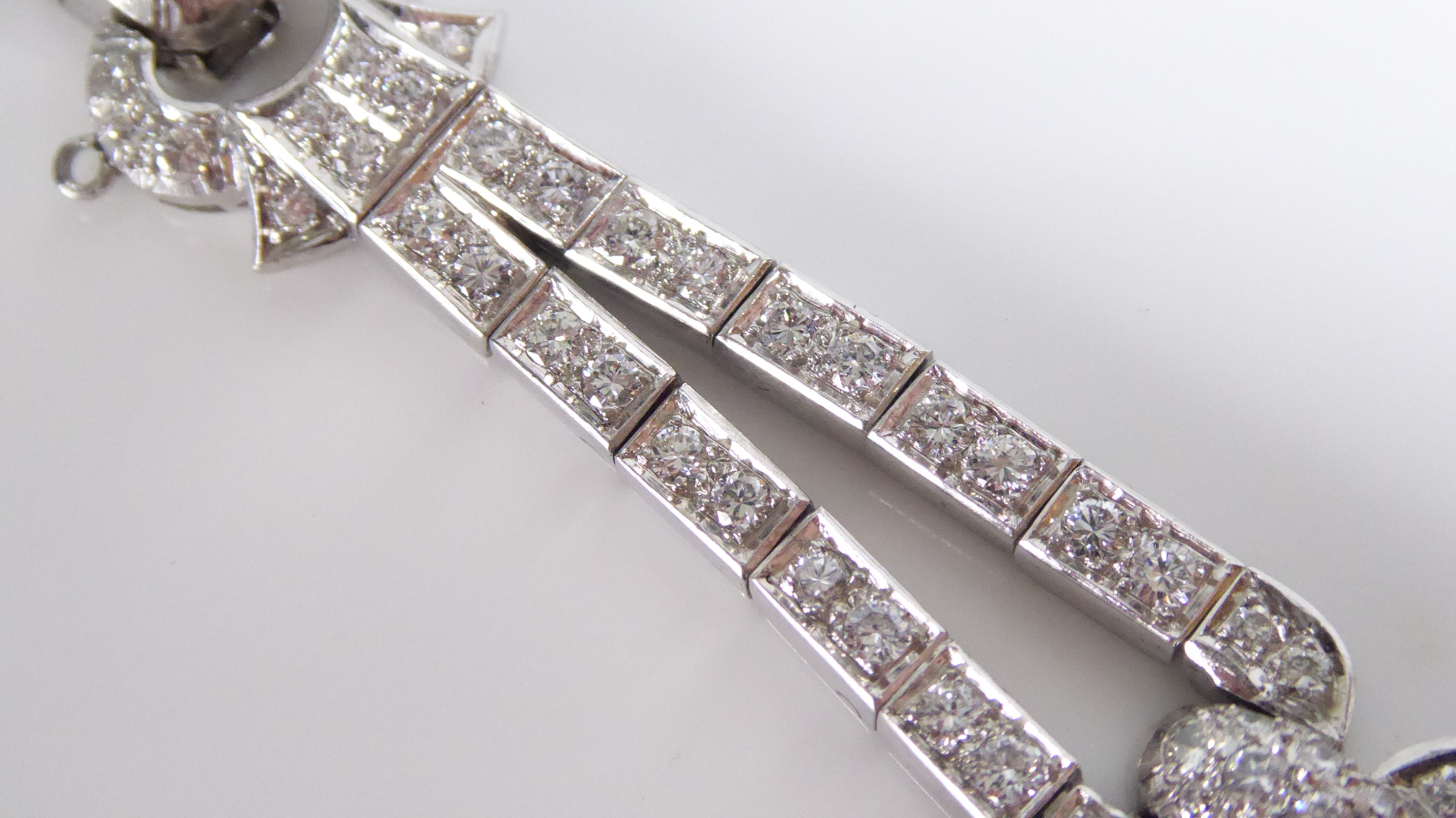 A PLATINUM AND DIAMOND BRACELET The arrangement of brilliant and baguette cut diamonds forming a - Image 6 of 8