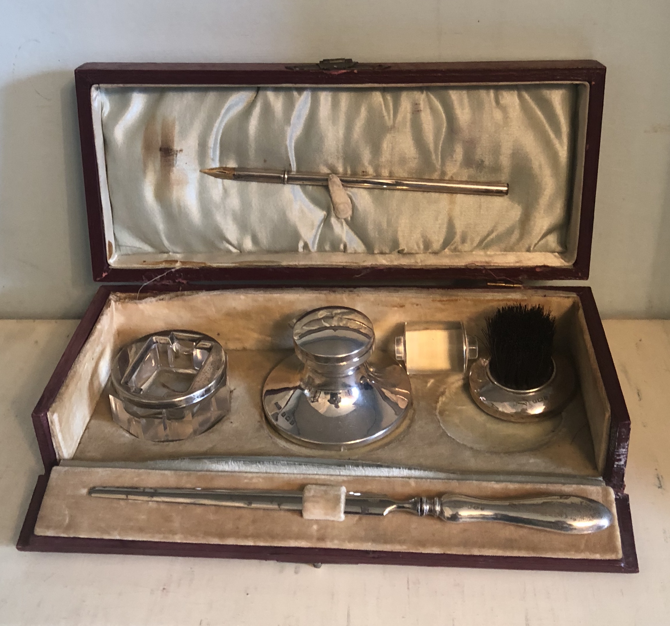 A LATE VICTORIAN SILVER TRAVELLING DESK SET Leather cased.