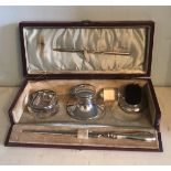 A LATE VICTORIAN SILVER TRAVELLING DESK SET Leather cased.