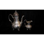 A VICTORIAN SILVER COFFEE POT AND CREAM JUG Having a melon form finial with fluted body,