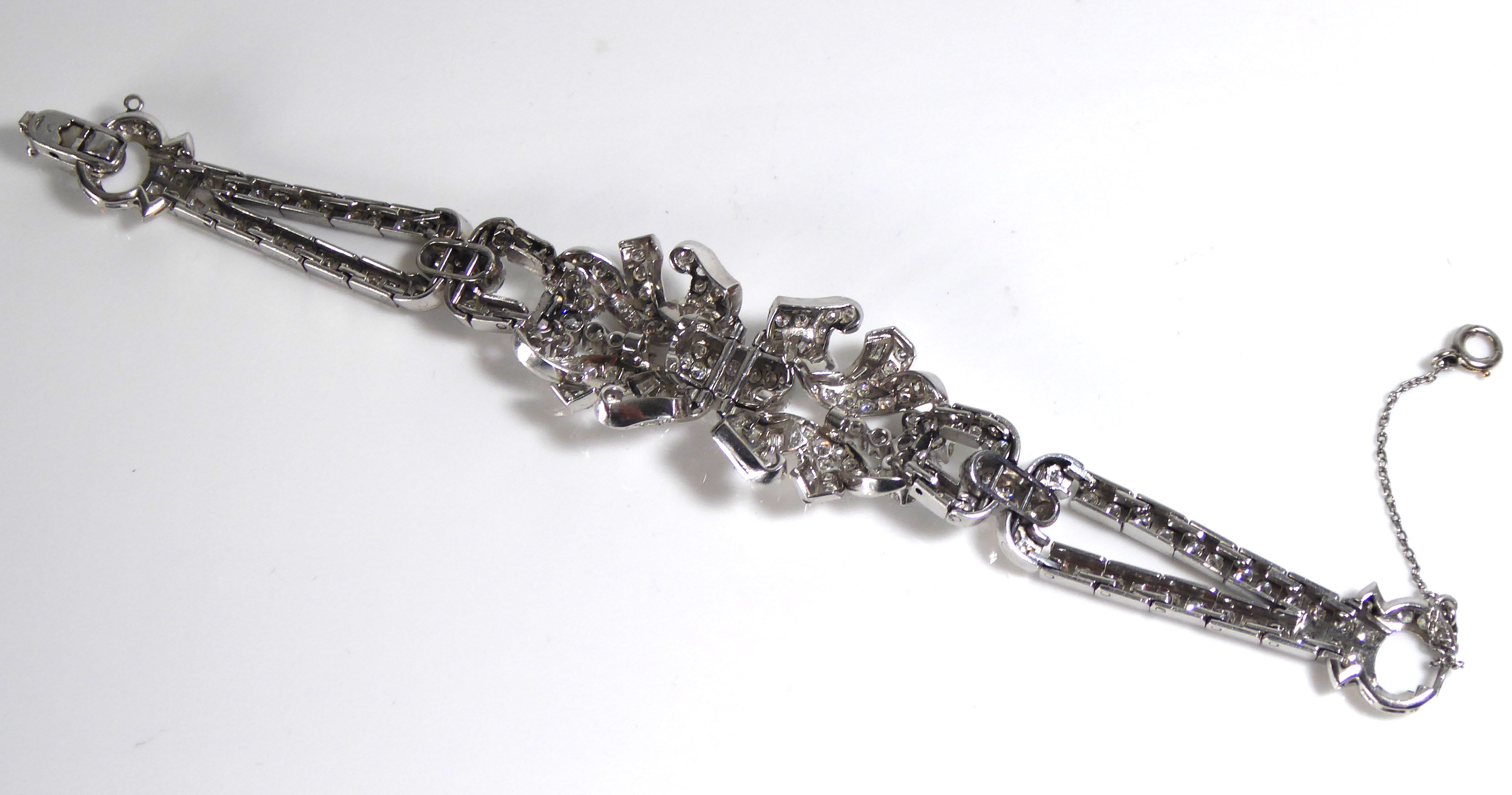 A PLATINUM AND DIAMOND BRACELET The arrangement of brilliant and baguette cut diamonds forming a - Image 8 of 8