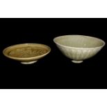 TWO CHINESE CELEDON GLAZED CONICAL POTTERY BOWLS With floral decoration. (largest bowl approx