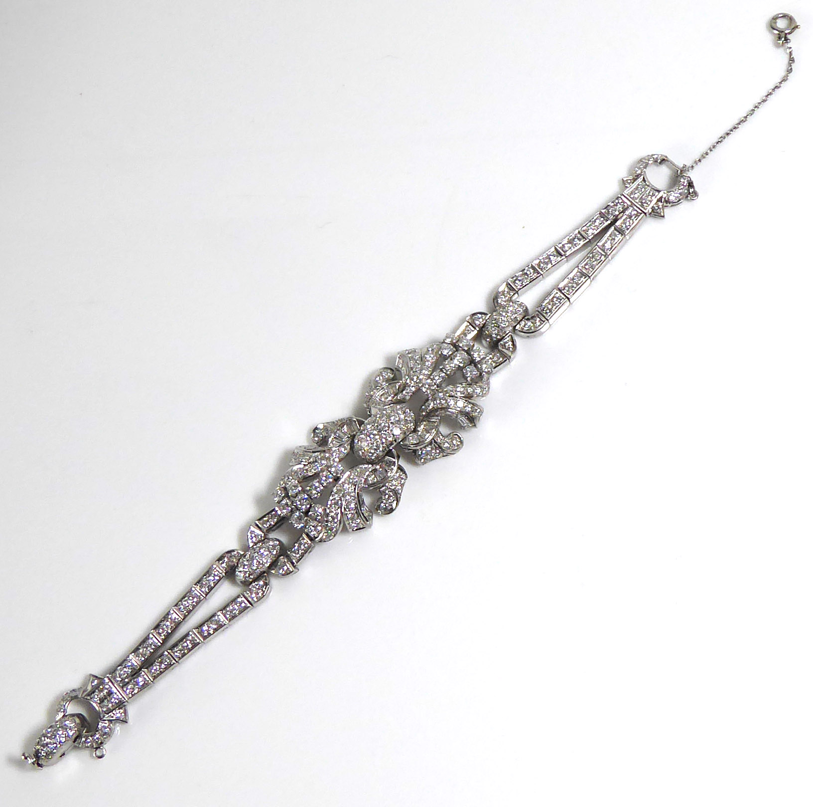 A PLATINUM AND DIAMOND BRACELET The arrangement of brilliant and baguette cut diamonds forming a - Image 3 of 8