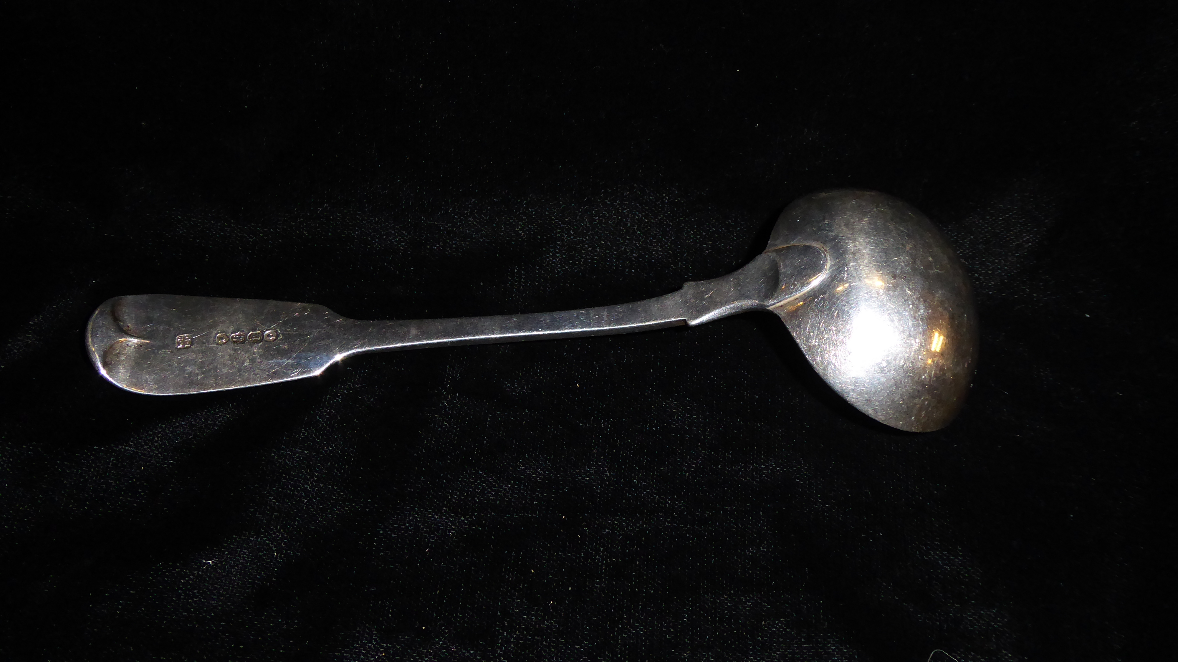 A VICTORIAN SILVER LADLE Fiddle pattern, with engraved family crest of a hand with sword, hallmarked - Image 2 of 2