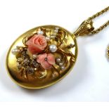 A CASED VICTORIAN 18CT GOLD, CORAL, DIAMOND AND SEED PEARL LOCKET AND CHAIN The oval shape with