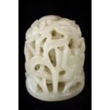 A CHINESE JADE CARVED HAT FINIAL The pierced dome intricately carved with birds and flowers. (approx