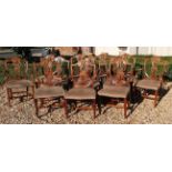 A SET OF TWELVE EDWARDIAN CARVED MAHOGANY REGENCY DESIGN SHIELD BACK DINING CHAIRS To include two