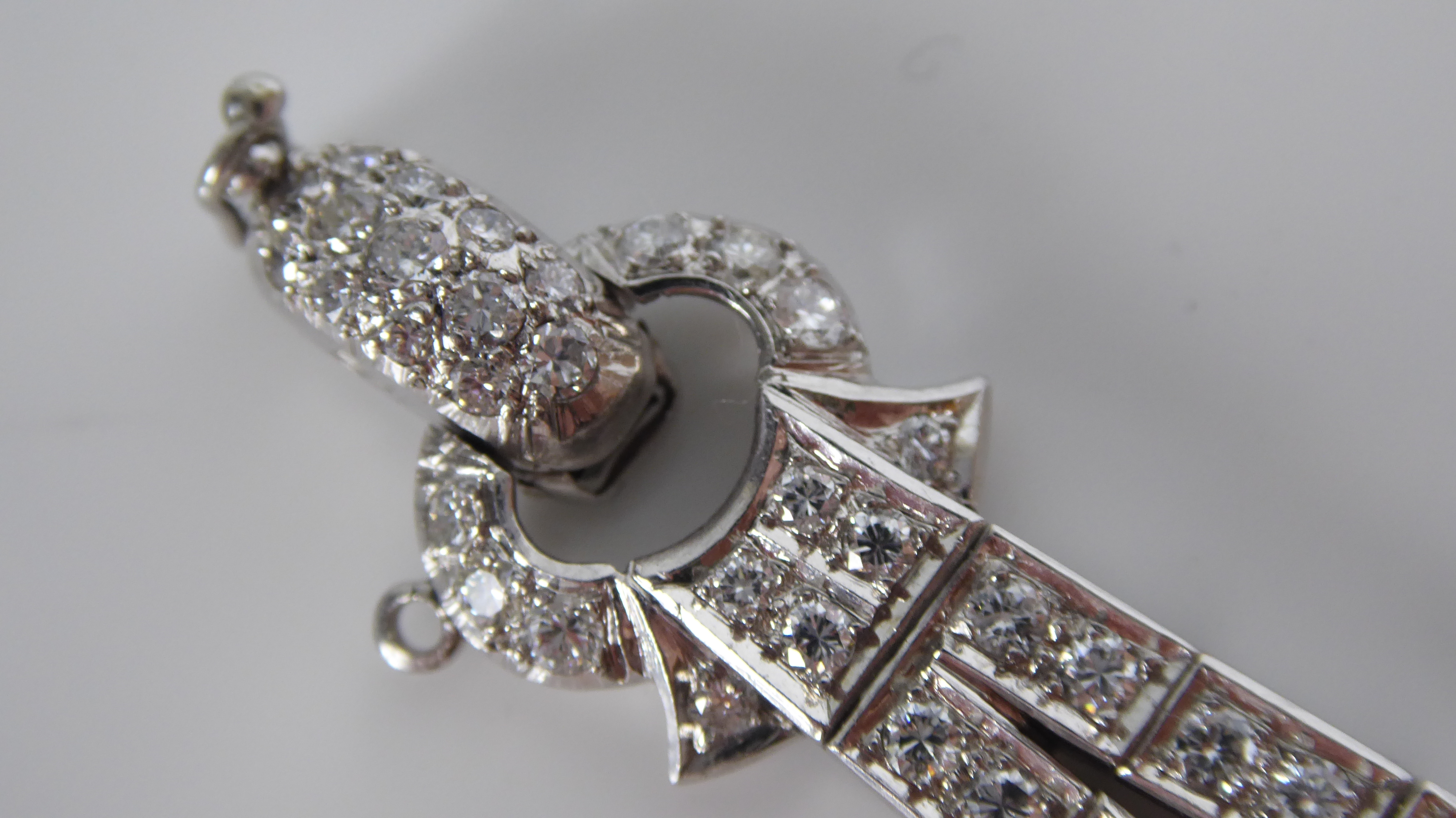 A PLATINUM AND DIAMOND BRACELET The arrangement of brilliant and baguette cut diamonds forming a - Image 7 of 8