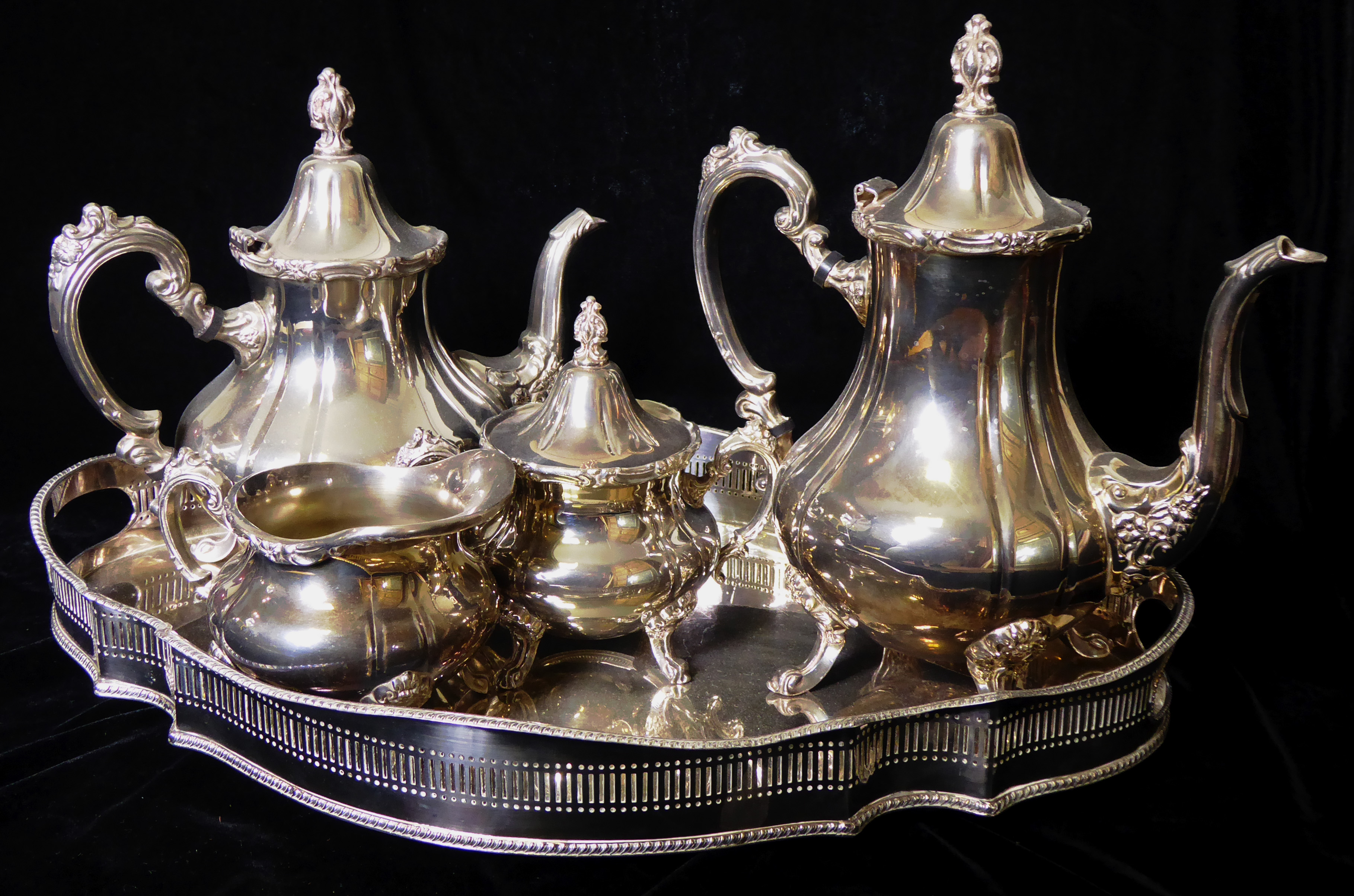 A 20TH CENTURY SILVER PLATED FOUR PIECE TEA SERVICE Comprising a teapot, coffee pot, covered sugar