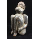AN EARLY 20TH CENTURY FIGURAL TRIBAL CARVING Modelled as seated monkey. (h 17cm)
