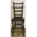 A 19TH CENTURY OAK LADDER BACK CORRECTIONAL CHAIR. (h 110cm x w 40cm x d 36cm)