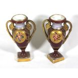 A PAIR OF VIENNA MINIATURE VASES The oval panels decorated with cherub musicians. (14cm)