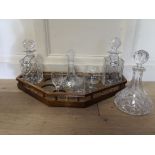 A TRAY TOP DRINKING SET To include three decanters, labels and glasses, along with another decanter.