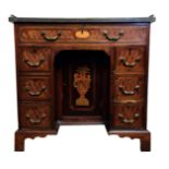 A GEORGE III EXOTIC MIXED WOOD INLAID KNEEHOLE DESK The leather top with pierced gallery over