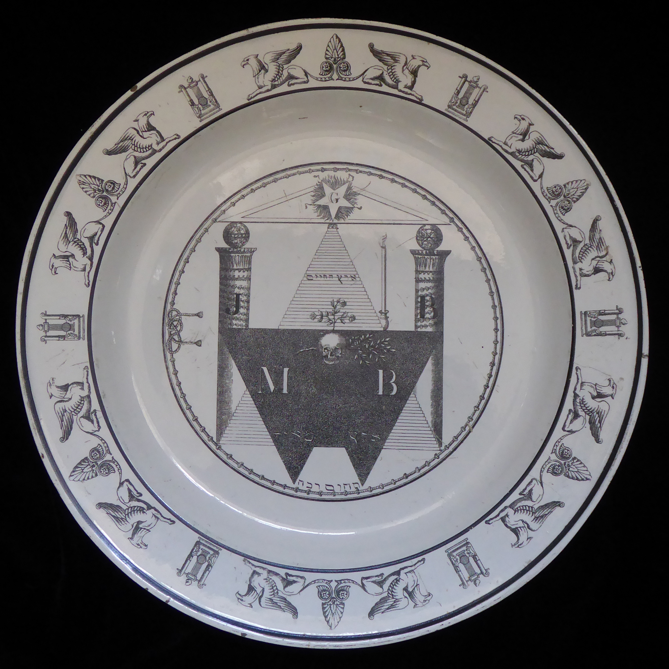 A FRENCH CREAMWARE PLATE Printed in black with a central circular panel enclosing Masonic symbols