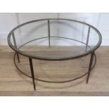 MANNER OF MAISON JANSEN, A 20TH CENTURY BRONZE AND GLASS CIRCULAR COFFEE TABLE Raised on reeded