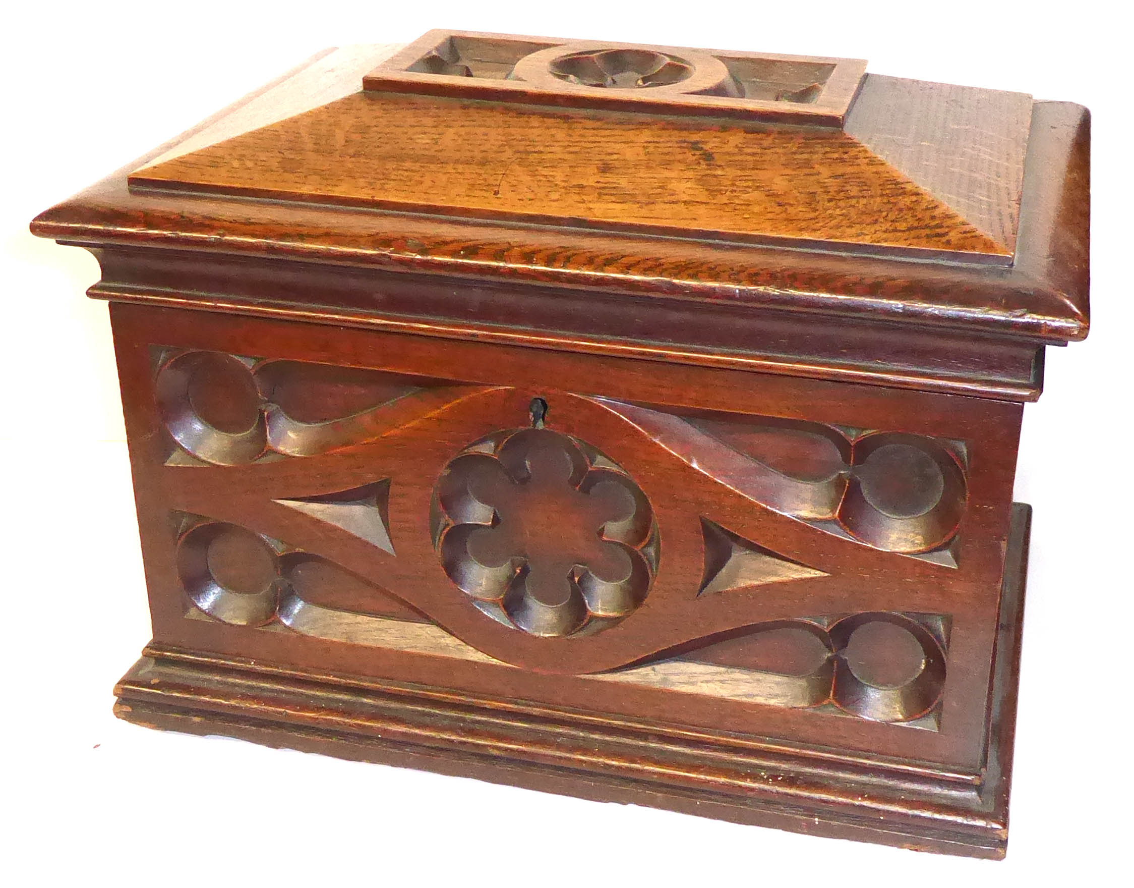 A 19TH CENTURY GOTHIC OAK DECANTER BOX Sarcophagus form with blind fretwork decoration, opening to