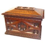 A 19TH CENTURY GOTHIC OAK DECANTER BOX Sarcophagus form with blind fretwork decoration, opening to