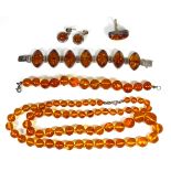 A COLLECTION OF VINTAGE SILVER AND AMBER JEWELLERY Comprising a bracelet set with lozenge form amber