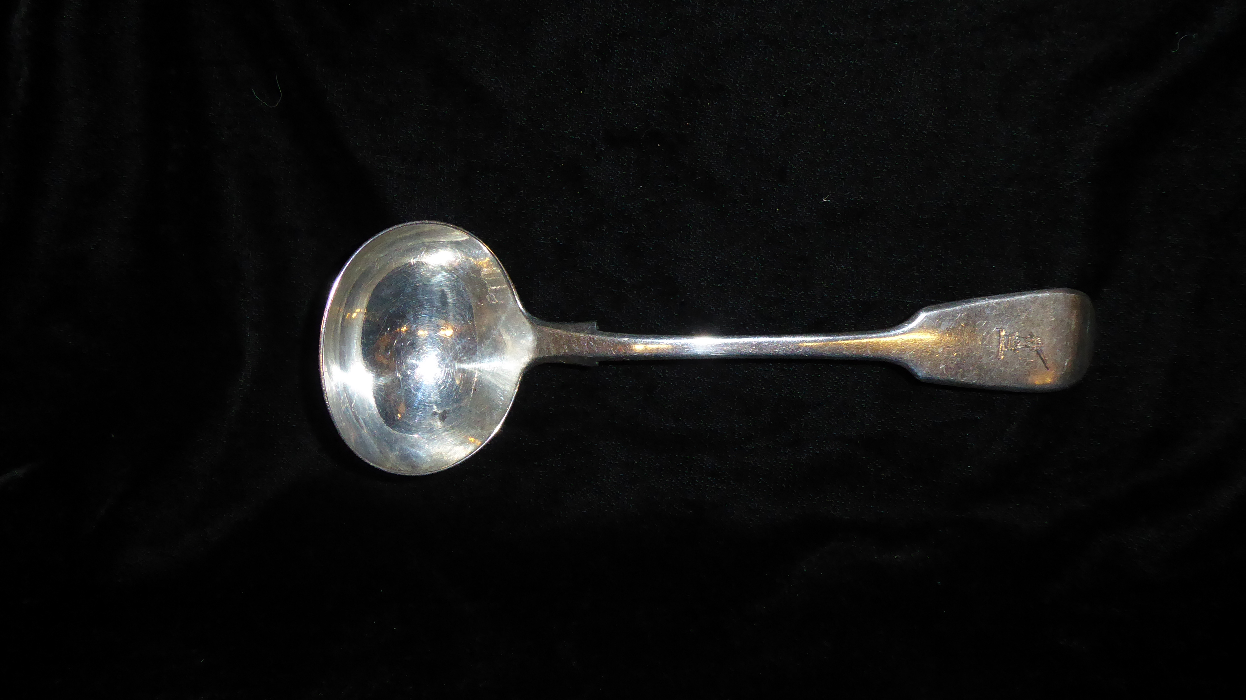 A VICTORIAN SILVER LADLE Fiddle pattern, with engraved family crest of a hand with sword, hallmarked