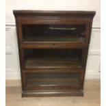 A 20TH CENTURY OAK GLOBEWERNICKE STYLE THREE SECTION BOOKCASE. (h 114cm x w 87cm x d 36cm)