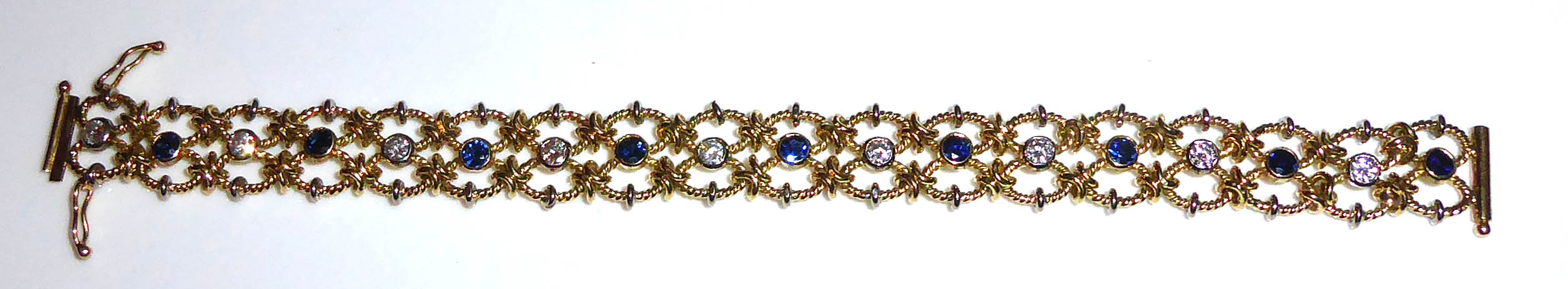 A VINTAGE YELLOW META, DIAMOND AND SAPPHIRE BRACELET The row of round cut diamonds interspersed with