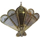 A BRASS PEACOCK FIRE SCREEN Along with an Edwardian bronze table lamp with engraved shade. (63cm)