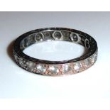 A WHITE METAL AND DIAMOND ETERNITY RING (size P).