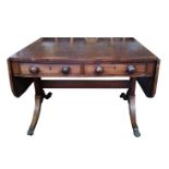 A 19TH CENTURY MAHOGANY AND ROSEWOOD CROSSBANDED SOFA TABLE With two drawers, raised on sabre legs