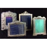 A COLLECTION OF FOUR 20TH CENTURY SILVER EASEL PHOTOGRAPH FRAMES Comprising a frame heavily embossed