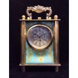 A VINTAGE BRASS CARRIAGE CLOCK Having a brass swing handle, the four panels having printed panels of