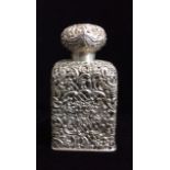 A LARGE VICTORIAN SILVER AND GLASS SCENT BOTTLE The hinged lid embossed with a facial mask, the