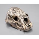 A LATE 19TH/EARLY 20TH CENTURY DAYAK TRIBE HEAD HUNTERS CARVED TROPHY SUN BEAR SKULL. (h 11cm x w