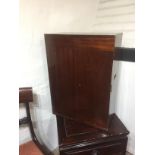 AN EDWARDIAN MAHOGANY TROPHY CABINET Applied with brass military fittings and two doors enclosing