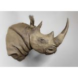 A 20TH CENTURY LIFE-SIZE IMITATION RHINOCEROS SHOULDER MOUNT. (h 105cm x w 90cm x d 160cm)