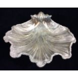 A LARGE VICTORIAN SILVER SHELL DISH Having a scrolled handle and scalloped edge, hallmarked Benjamin