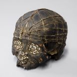 A 19TH CENTURY DAYAK TRIBE HEAD HUNTERS CARVED TROPHY HUMAN SKULL. (h 16cm x w 18cm x d 15cm)